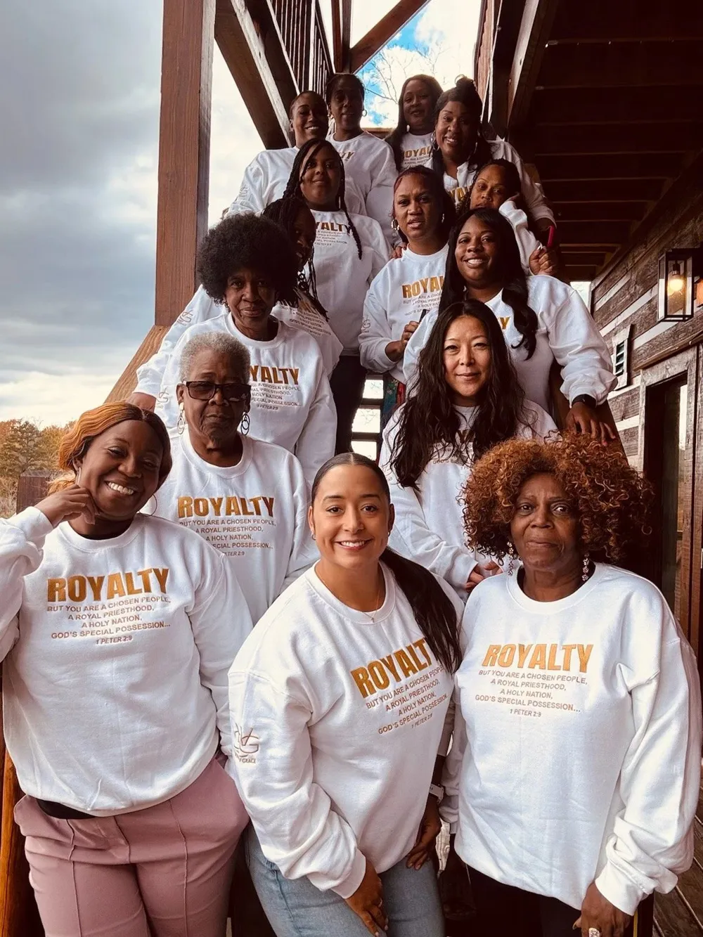 Ministry members wearing matching Royalty shirts, smiling together on retreat